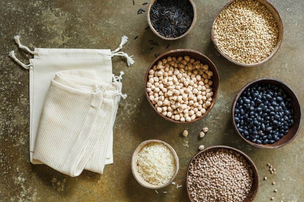Eco cotton bags and organic grains and cereals in coconut bowls