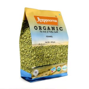 Annapoorna Organic Fennel packaging, predominantly yellow with a landscape scene and a visual of fennel seeds. The package indicates it as a 100 grams organic product with the tagline 'The Pride of Mother Earth' and USDA Organic and India Organic certification logos.