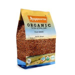 "Annapoorna Organic Flax Seeds packaging, predominantly yellow with a visual of flax seeds. The package indicates it as a 100 grams organic product with the tagline 'The Pride of Mother Earth' and USDA Organic and India Organic certification logos."