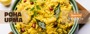 Close-up view of Poha Upma, an Indian dish made from flattened rice, garnished with herbs and peanuts, with the text 'Poha Upma' and the Annapoorna Organic logo, indicating the real taste of Indian food.