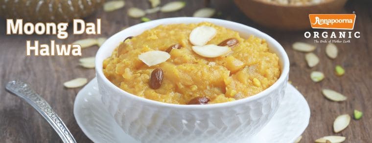 A bowl of Moong Dal Halwa garnished with nuts, with the label "Annapoorna Organic The Old Time Gold.